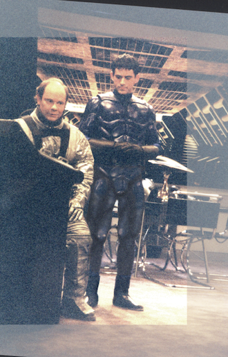 The completed hero suit worn by an actor on set, photographed from a video monitor