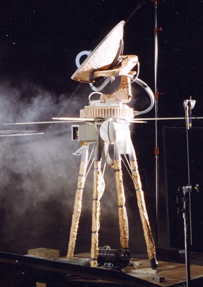 Foil-wrapped satellite rig on a smoke-filled soundstage, built for the cut opening of Independence Day